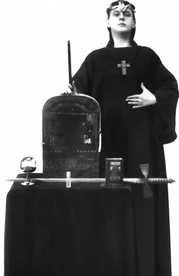 The magician, in his robe and crown, armed with wand, cup, sword, pantacle, bell, book, and holy oil.